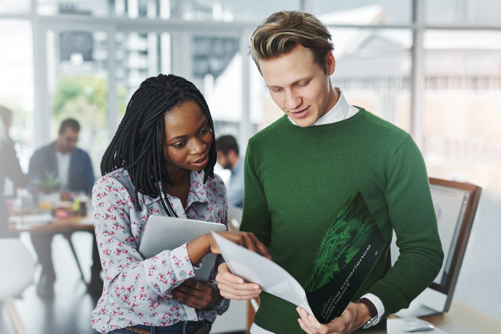 Two people looking at the audit report from Like-Minded